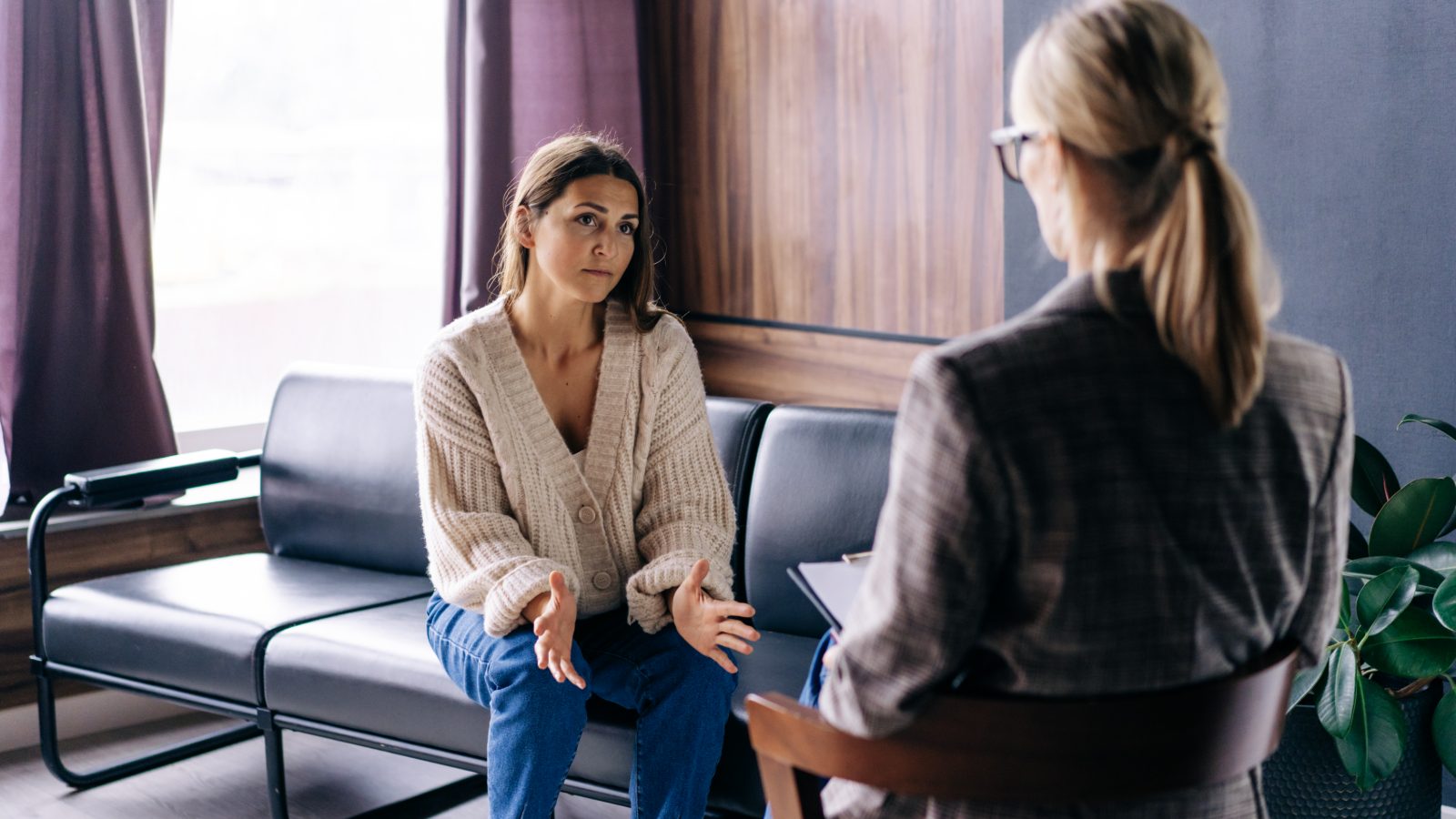 Therapiegespräch zwischen zwei Personen in hellen Sesseln